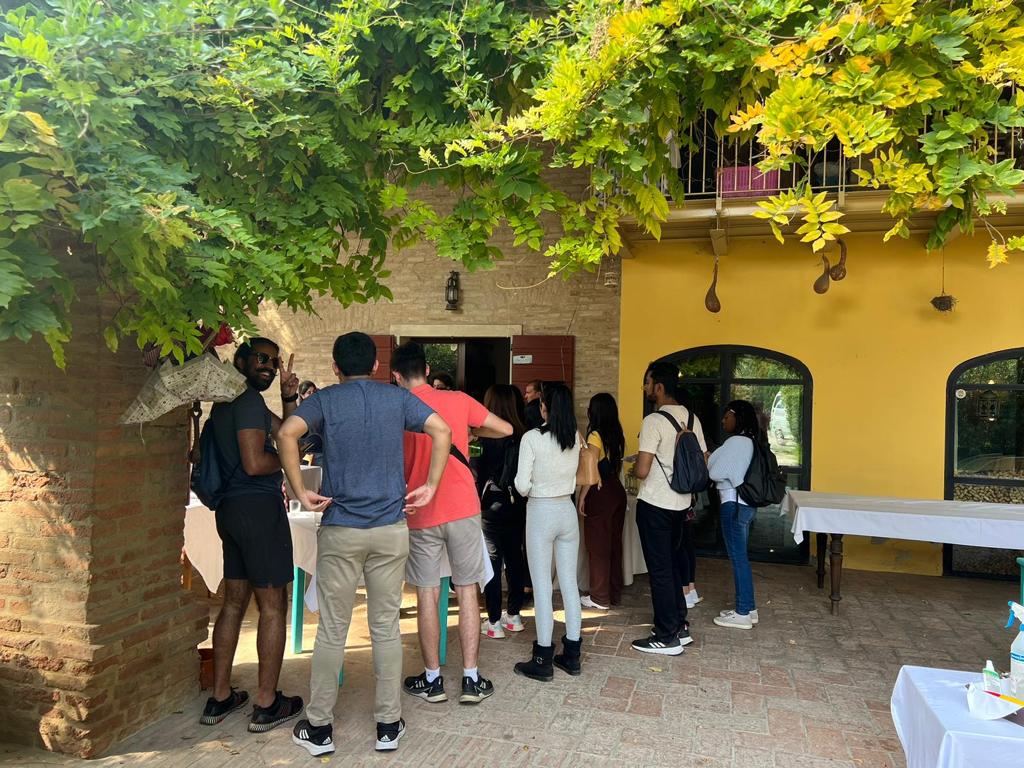 a group of students stand in a courtyard in Italy